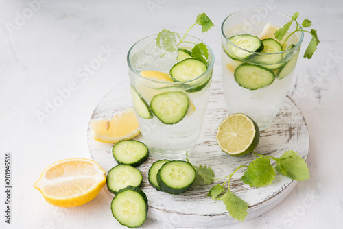 A glass of refreshing homemade lemonade with ice, cucumber and mint. Horizontal orientation.