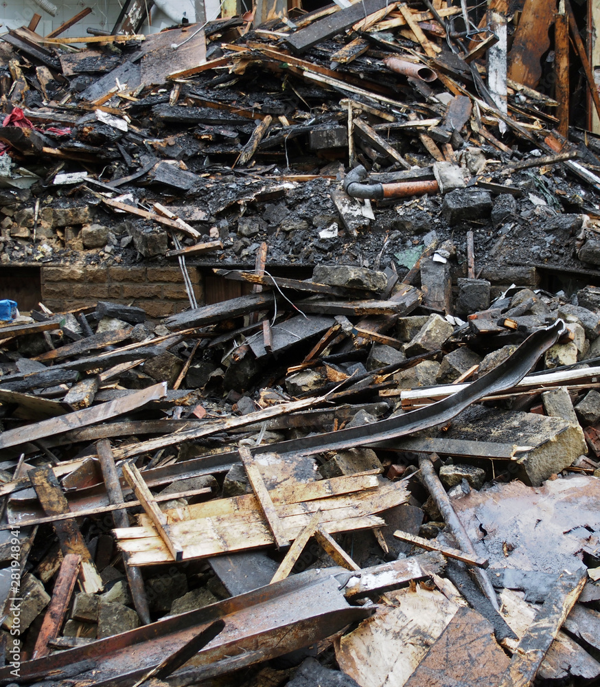 a heap of burned and scattered bricks beams and rubble after a fire in a large building a heap of burned and scattered bricks beams and rubble after a fire in a large building