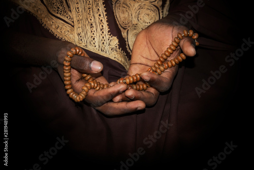 Photography Hands of a Muslim man holding a rosary