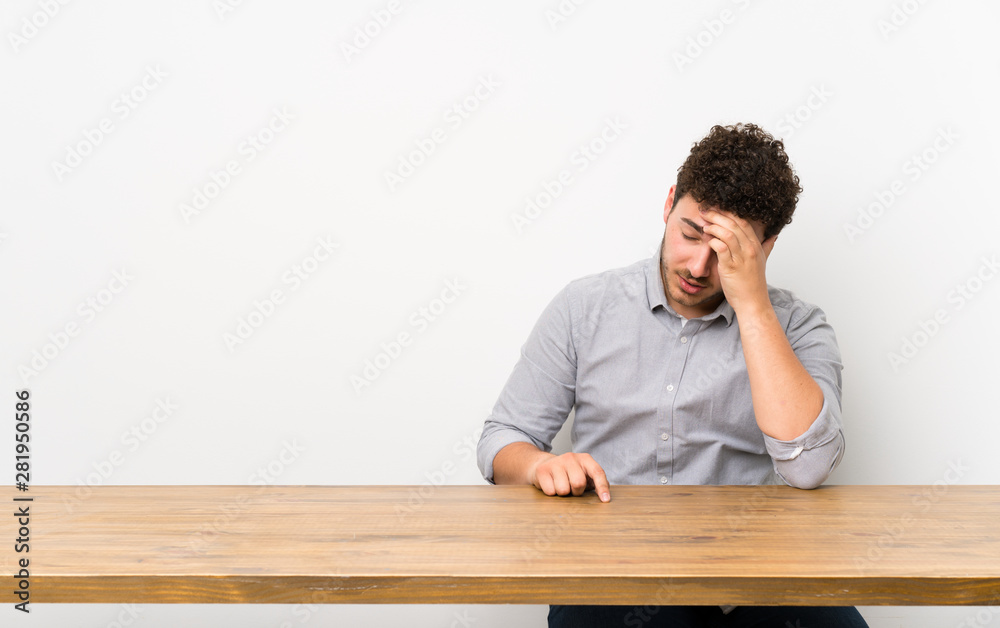 Young man with a table with tired and sick expression Young man with a table with tired and sick expression
