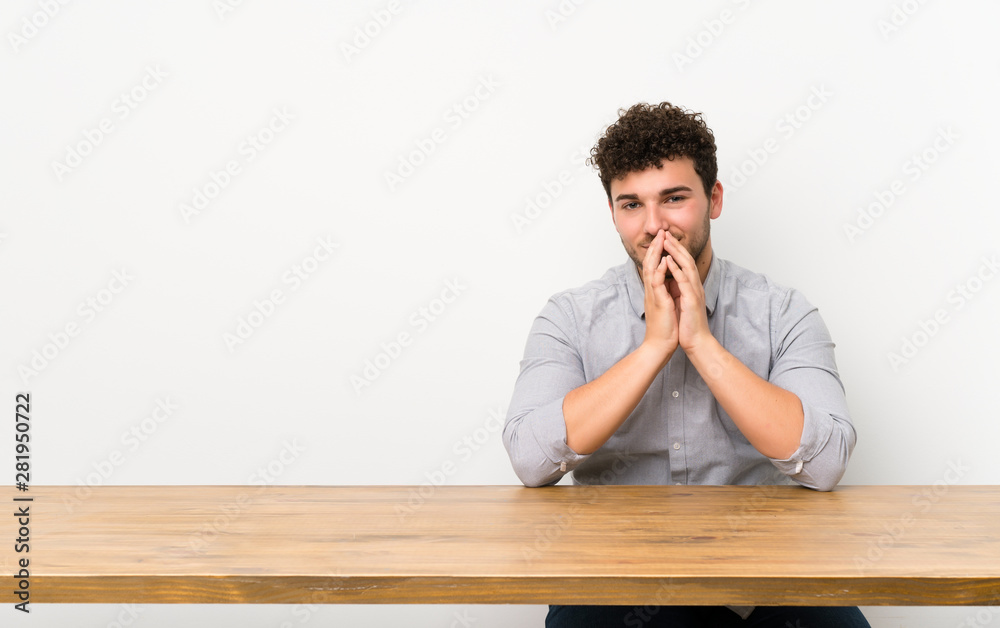 Young man with a table scheming something Young man with a table scheming something
