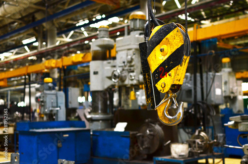 Bridge lifting Crane Hook against the background of the Assembly Line industrial factory. The concept of a heavy automotive manufacturing process at an industrial plant, background, texture - Image