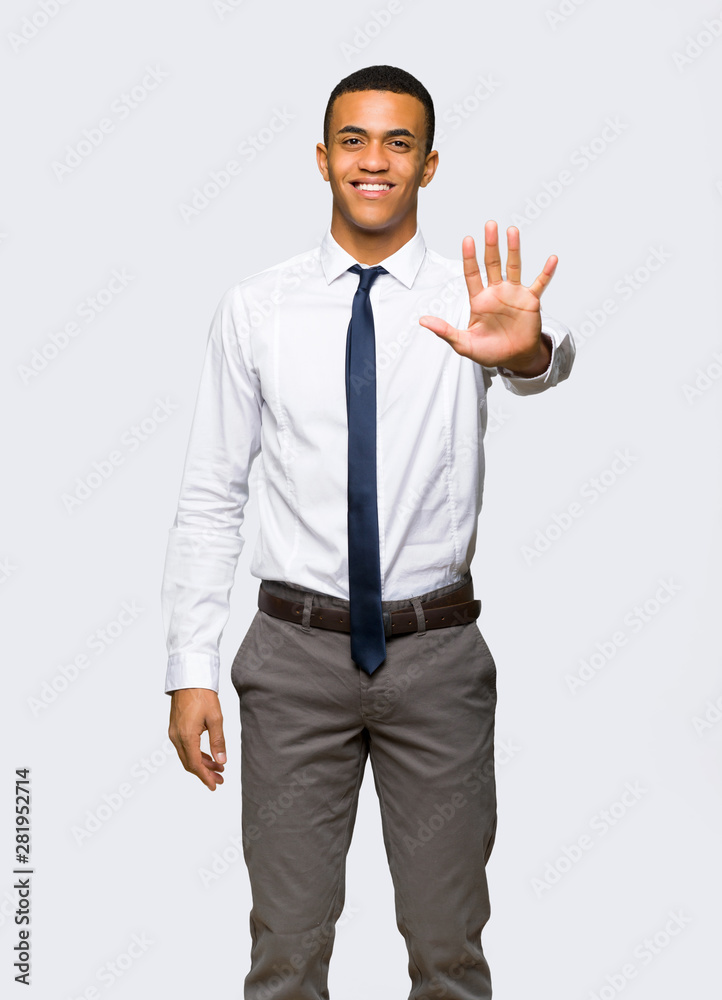 Young afro american businessman counting five with fingers on isolated background Young afro american businessman counting five with fingers on isolated background