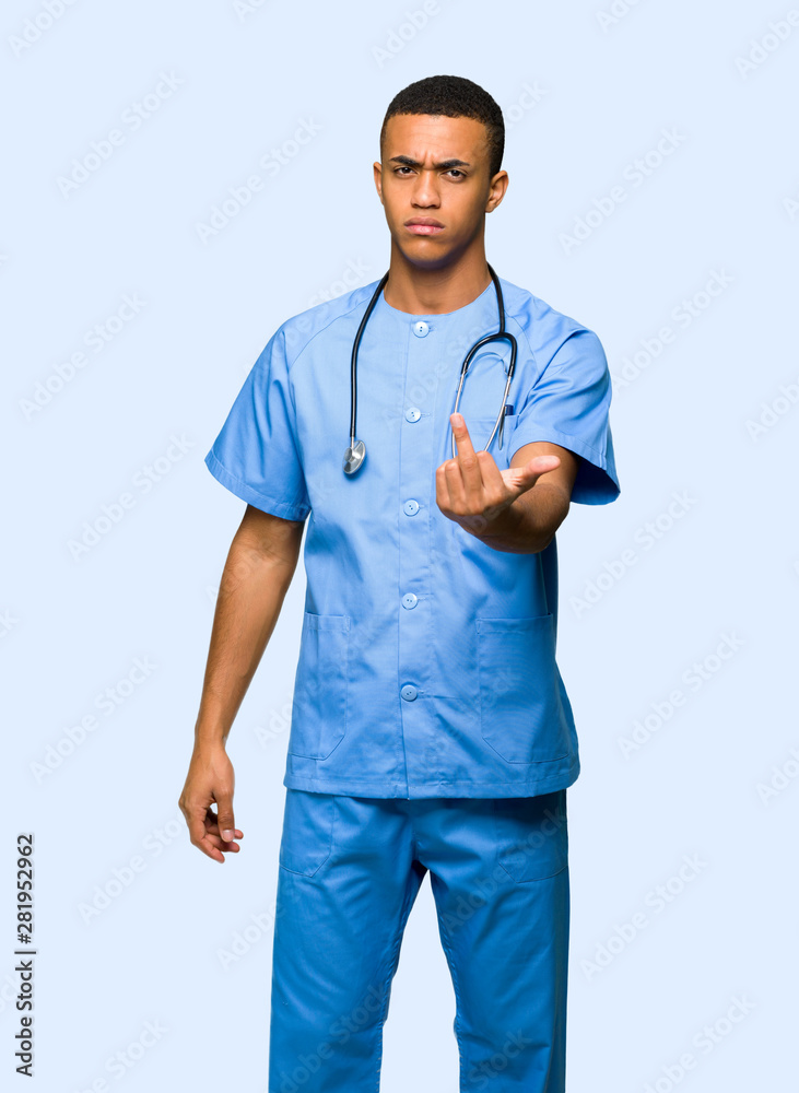 Surgeon doctor man making horn gesture on isolated background Surgeon doctor man making horn gesture on isolated background
