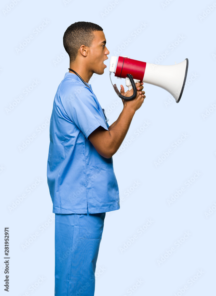 Surgeon doctor man shouting through a megaphone to announce something in lateral position on isolated background Surgeon doctor man shouting through a megaphone to announce something in lateral position on isolated background