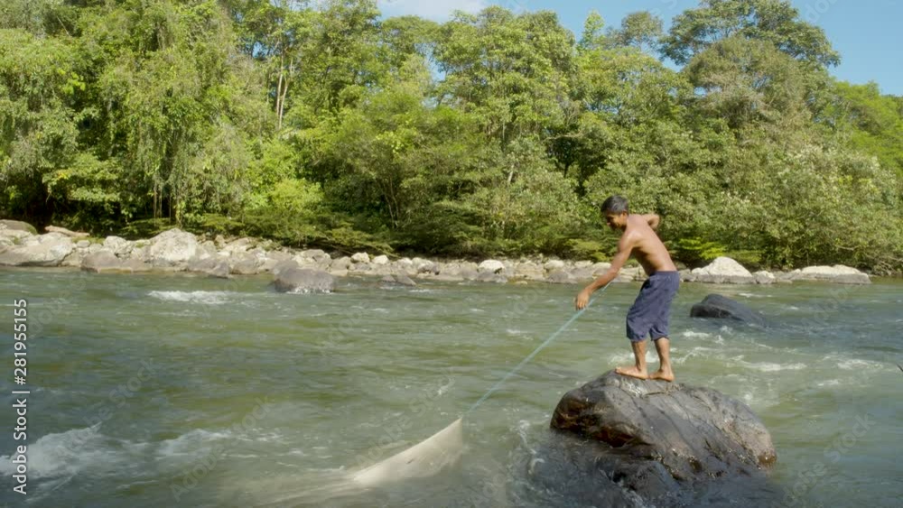 Indigenous Tribe People Fishing By Amazonian River In Ecuador Indigenous Tribe People Fishing By Amazonian River In Ecuador