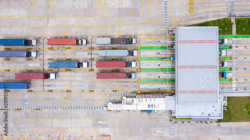 Принти на полотні Aerial view large container trucks entering with container of goods through the main entrance gate in the industrial port