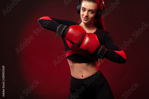 Young woman sportsman boxer on boxing training. Girl wearing gloves, sportswear.