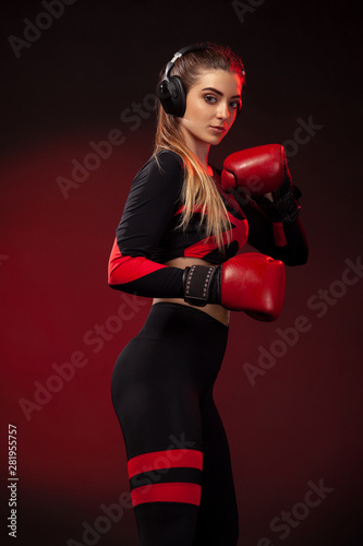 Young woman sportsman boxer on boxing training. Girl wearing gloves, sportswear.