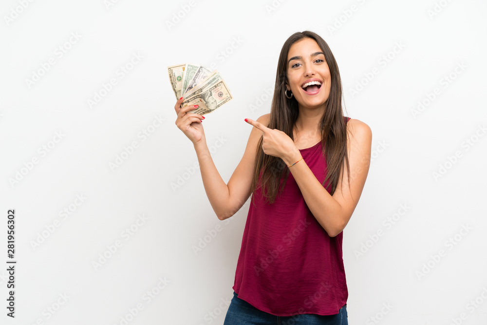 Young woman over isolated white background taking a lot of money