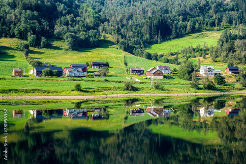 Little village along lake Vangsvatnet reflected in the water near Voss Hordaland county Norway photo