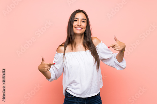 Young woman over isolated pink background proud and self-satisfied