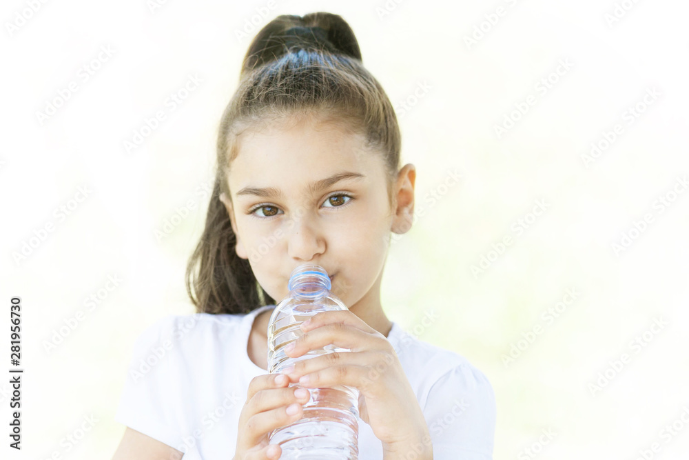 Cute adorable child girl drinking clear water on white background. Pure water Cute adorable child girl drinking clear water on white background. Pure water