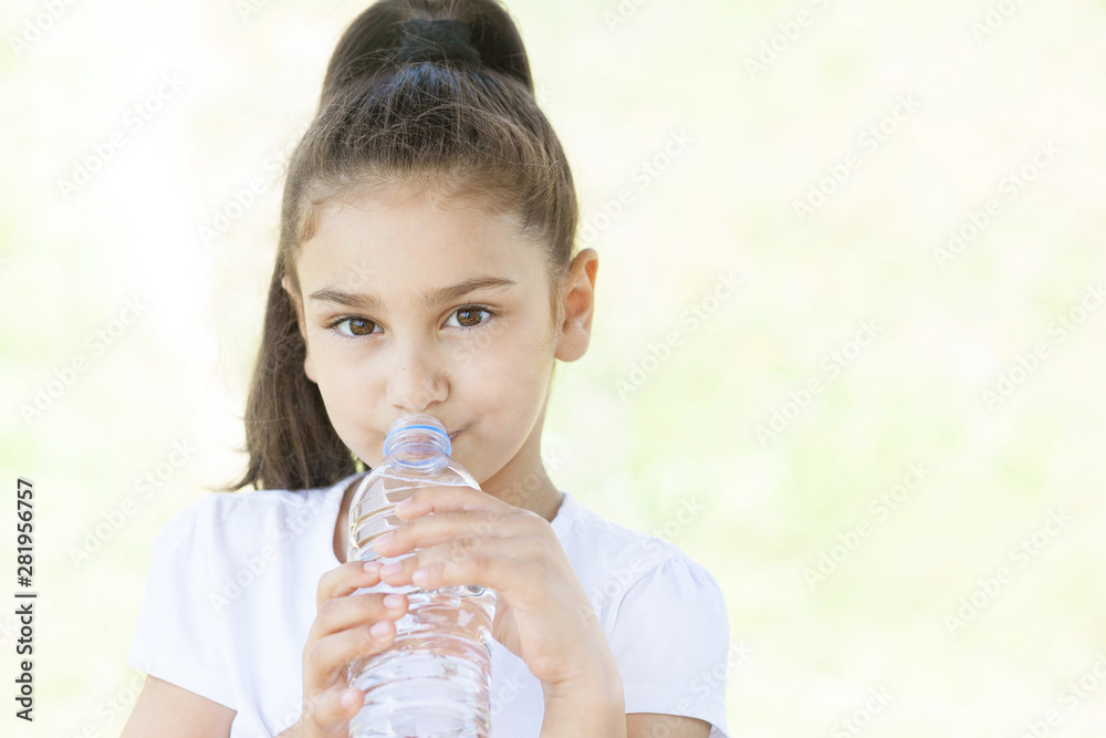 Cute adorable child girl drinking clear water on white background. Pure water Cute adorable child girl drinking clear water on white background. Pure water