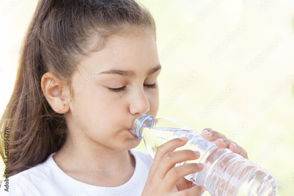 Cute adorable child girl drinking clear water on white background. Pure water Cute adorable child girl drinking clear water on white background. Pure water