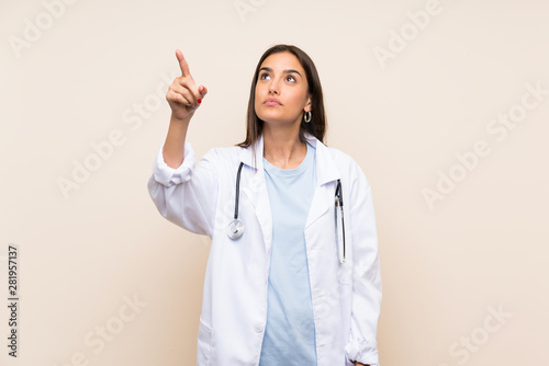Young doctor woman over isolated background touching on transparent screen