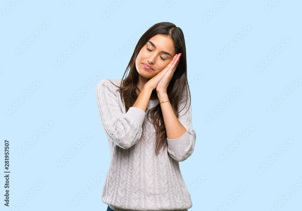 Young hispanic brunette woman making sleep gesture in dorable expression over isolated background Young hispanic brunette woman making sleep gesture in dorable expression over isolated background