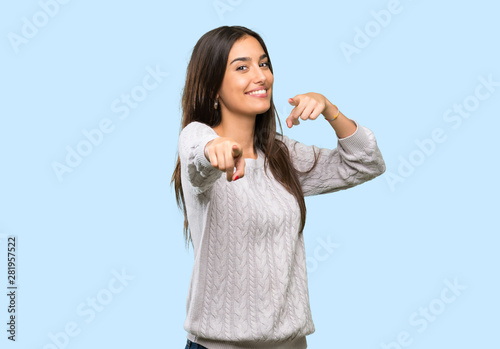 Young hispanic brunette woman points finger at you while smiling over isolated background photo