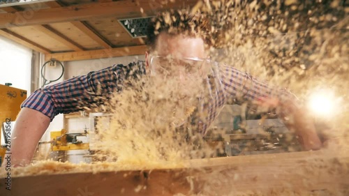 Slow motion of wood chippings getting blown away photo