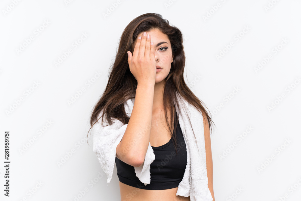 Teenager sport girl over isolated white background covering a eye by hand Teenager sport girl over isolated white background covering a eye by hand