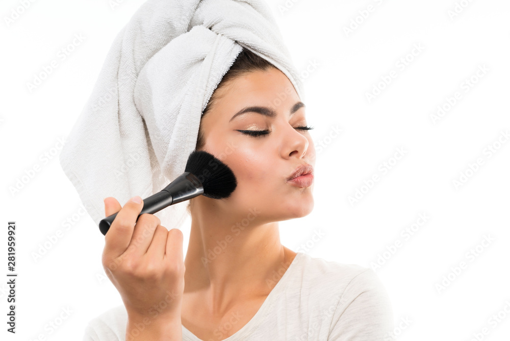 Teenager girl over isolated white background with makeup brush