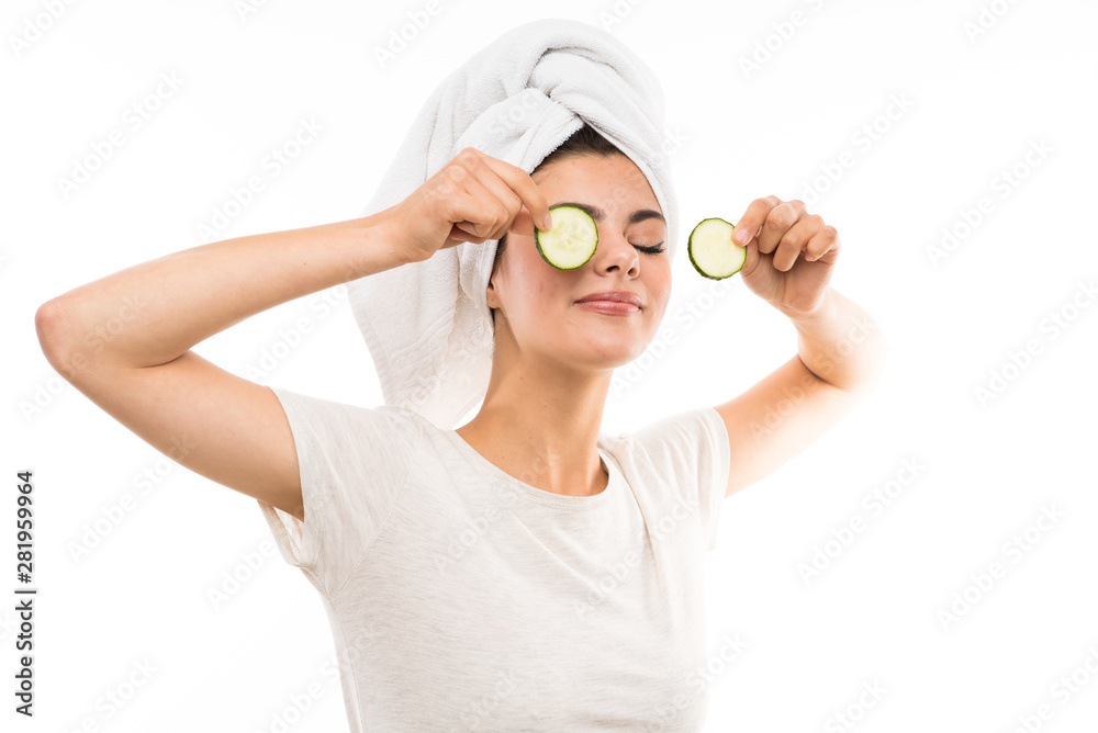 Beautiful young woman holding slices of cucumber. Beautiful young woman holding slices of cucumber.