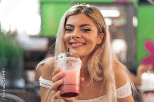 Girl drinking a strawberry smoothie