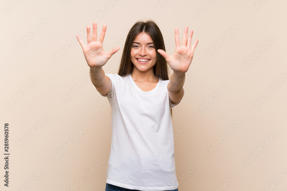 Pretty young girl over isolated background counting ten with fingers Pretty young girl over isolated background counting ten with fingers