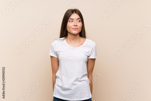 Pretty young girl over isolated background making doubts gesture looking side