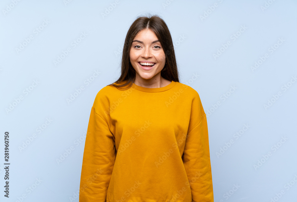 Caucasian young woman over isolated blue wall with surprise facial expression Caucasian young woman over isolated blue wall with surprise facial expression