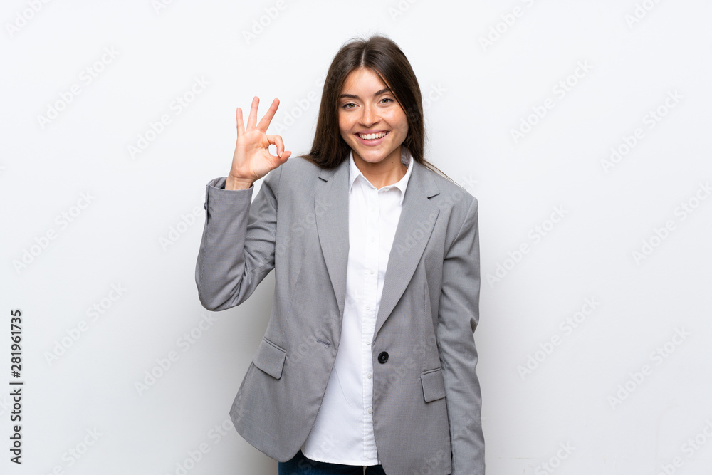 Young business woman over isolated white background showing ok sign with fingers Young business woman over isolated white background showing ok sign with fingers