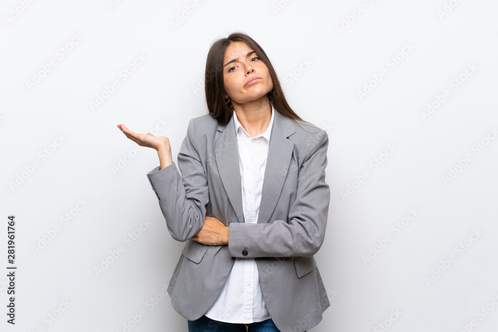 Young business woman over isolated white background unhappy for not understand something Young business woman over isolated white background unhappy for not understand something
