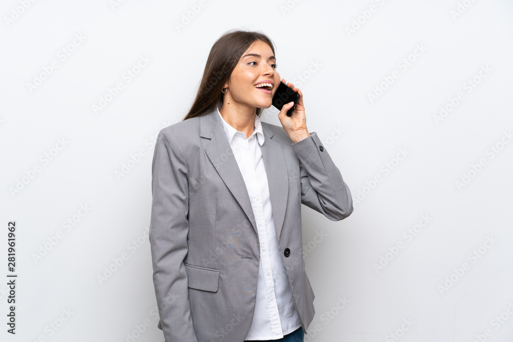 Young business woman over isolated white background keeping a conversation with the mobile phone Young business woman over isolated white background keeping a conversation with the mobile phone