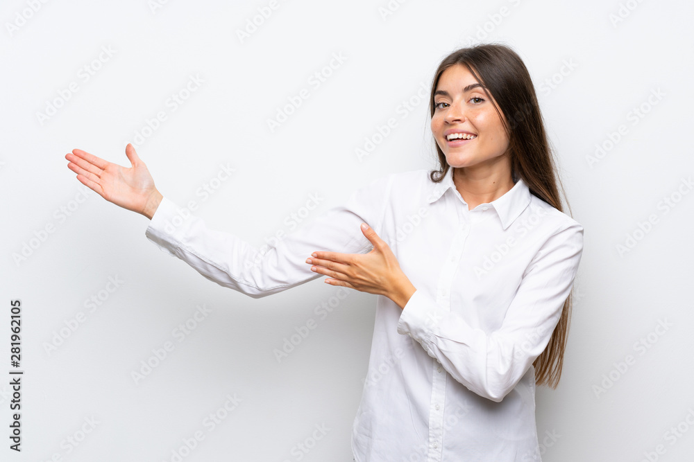 Young woman over isolated white background extending hands to the side for inviting to come Young woman over isolated white background extending hands to the side for inviting to come