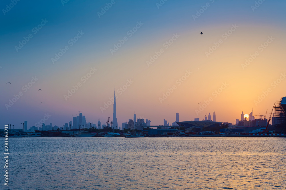 sunset in Dubai city view with birds flying
