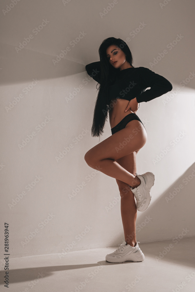 Sexy hot woman in lingerie and sneakers posing in studio on black  background. Seductive nude glamour young girl model portrait. Underwear  passion. Stock Photo | Adobe Stock