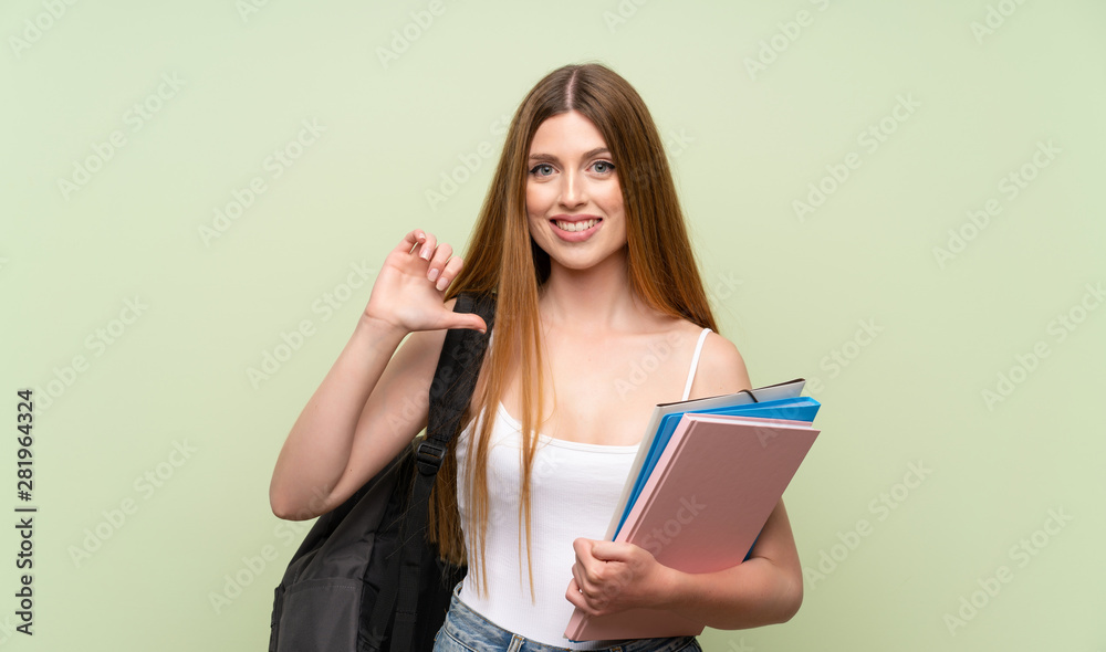 Young student woman over isolated green background proud and self-satisfied Young student woman over isolated green background proud and self-satisfied