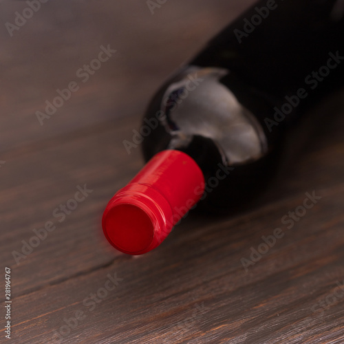 Red wine bottle on wooden table.Copyspace