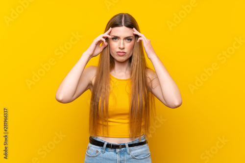 Young woman over isolated yellow background unhappy and frustrated with something. Negative facial expression