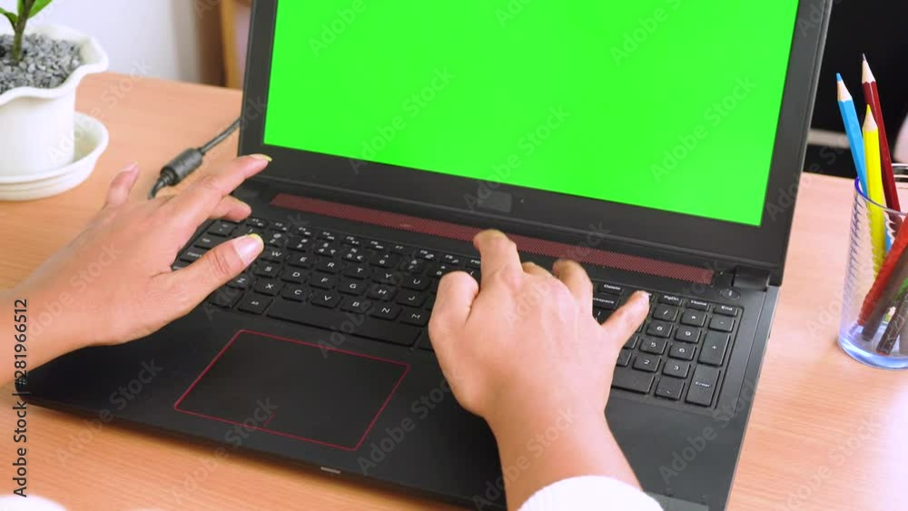 Woman hand using laptop with key green screen. Lady hand typing on a laptop computer Woman hand using laptop with key green screen. Lady hand typing on a laptop computer