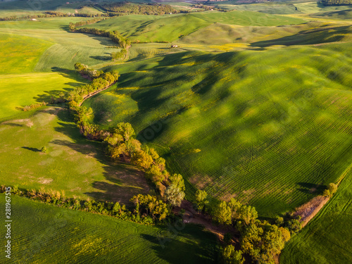 Aerial drone landscape of famous Tuscany hills, Italy spring fields sunset Asciano Siena Firenze