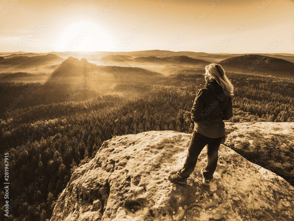 Fototapeta premium Girl watch Sun rising at horizon. Colorful spring valley