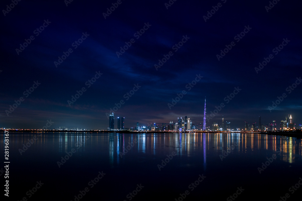 Fototapeta premium Dubai Skyline City Lights & Reflections in Water, Dubai, United Arab Emirates