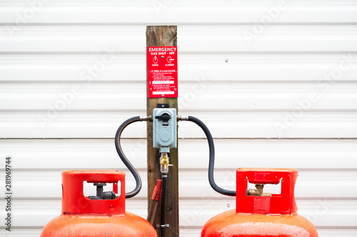 Calor gas cylinder bottles refilling with hose at refill point within caravan park site photo