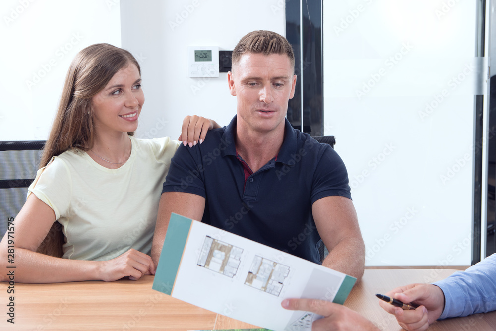 Obraz premium portrait of nice young couple in business office background