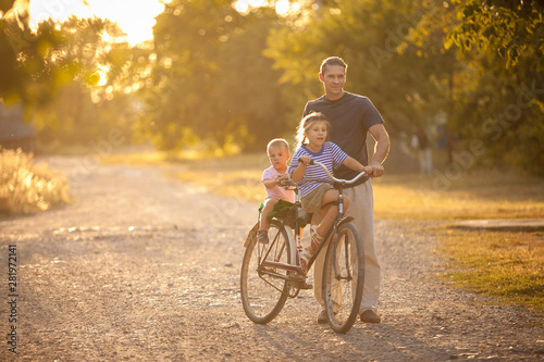 Father and children on bicycle