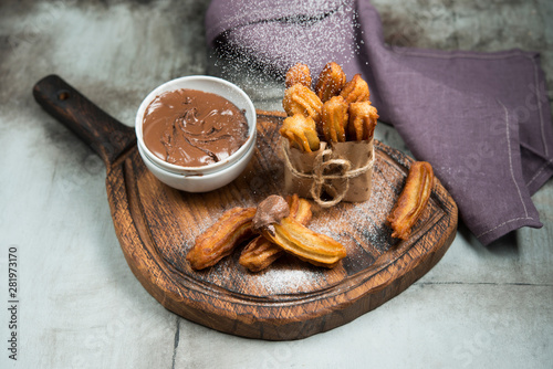 Traditional Spanish dessert. Churos with chocolate. Horizontal photo. photo