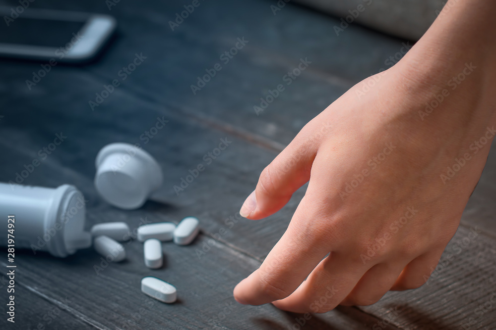 Pills overdose concept. The girl lost consciousness from an overdose of pills and is unable to call medical assistance