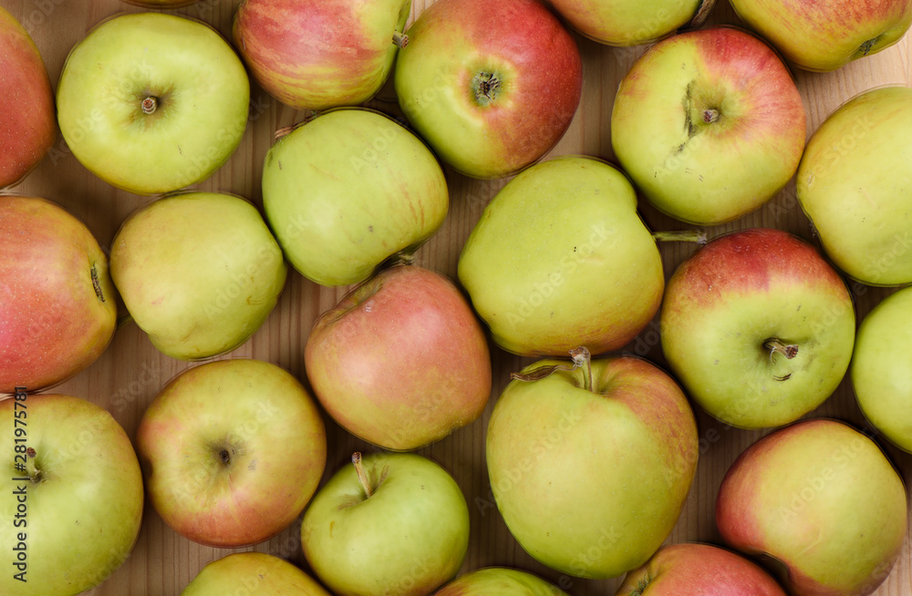 Ripe apples on a wooden background. A lot of apples as a background. Ripe apples on a wooden background. A lot of apples as a background.