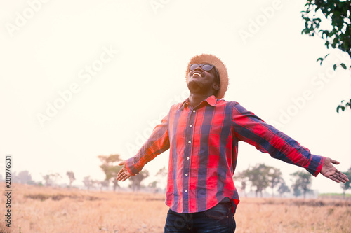 Portrait of african traveler smiling and enjoying his recreation time in nature.Concept of tourism day